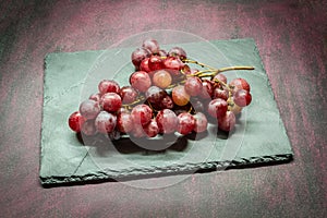 Red grapes on stone