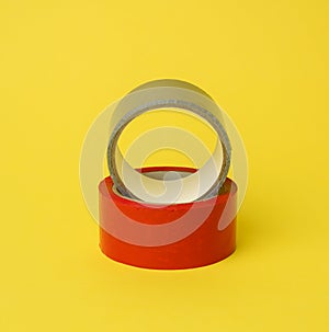 Red and gray scotch tape isolated on a yellow background