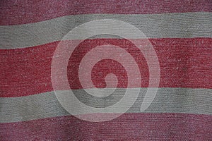 Red gray striped fabric texture from an old piece of cloth