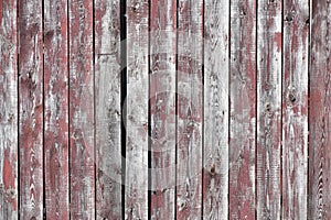 Red-gray wooden background. vertical boards. old paint peels off. old boards. Red gray wood texture of a worn painted board. Red