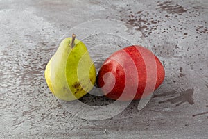 Red and green anjou pears on a gray mottled background side view photo