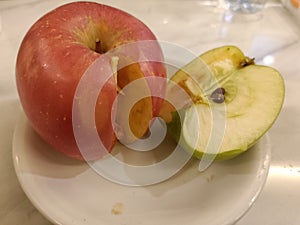 red and green apple above the plate