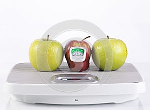 Red and green apple with measurement tool