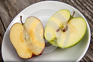 Red and green apple sliced in half