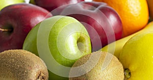 red green apples with ripe bananas and kiwi orange lemon on a white background