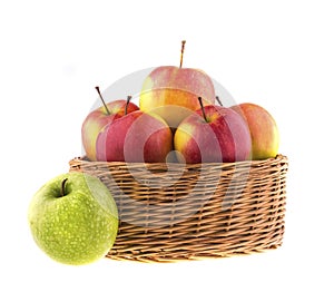Red and green apples in a wicker baskets