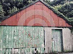 Red and green barn in Clifden Ireland-cloudy day