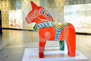 Red and green big Swedish Dala horse. The traditional wooden Dalecarlian Horse symbol of Swedish Dalarna province photo