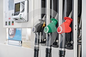 Red green black color fuel gasoline dispenser background. Close-up fuel nozzles on petrol and diesel fuel.