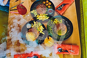 Red, green,black mini burgers with quinoa and vegetables.