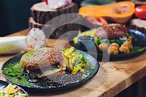 Red, green,black mini burgers with quinoa and vegetables.