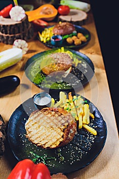 Red, green,black mini burgers with quinoa and vegetables.