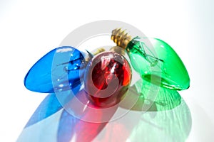 Red Green and Blue Christmas Lightbulbs on White Background