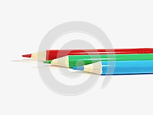 Red, green, blue-colored pencil line up on a white background photo