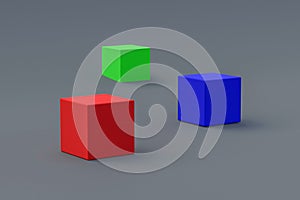 Red, green and blue cubes on gray background