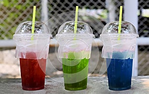 Red, Green, Blue soft drinks in the plastic tumbler