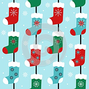 Red, green and blue traditional vertical seamless pattern with christmas stockings and snowflakes