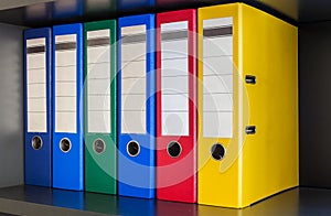 Red, green, blue and yellow office folders