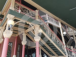 Red and green building with columns and stairs