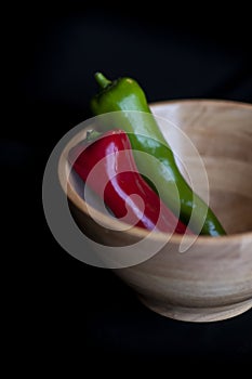 Red and green chilli on a black background