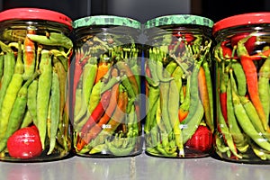 Red and green chilli peppers preserved in vinegar