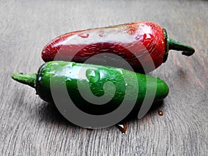 red and green chillis on woodtable