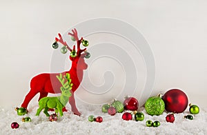 Red and green christmas decoration with reindeer and snow for a