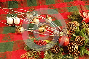 CHRISTMAS decorations, white branches, 5 gold jingle bells, two white doves, evergreen branches, pine cones, red sparkly ball,