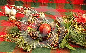 CHRISTMAS decorations, two white doves, gold jingle bells, evergreen branches, pine cones