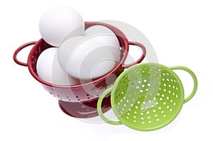 Red and Green Colanders with Fresh Eggs