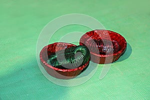 Red and green color bangle in bowl