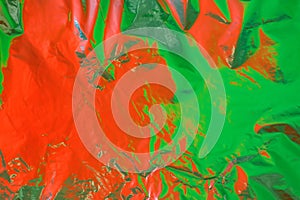 Red and green color reflection on cellophane film as abstract colorful background