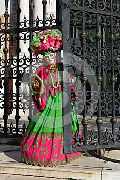Red green costumed masked woman portrait