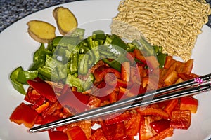 Red and green cut peppers, ready for roasting