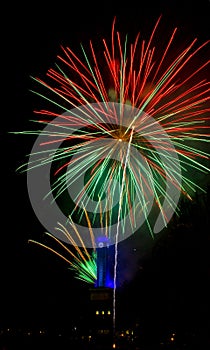 Red green firework in Ostrava with city hall clock