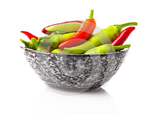 Red and green hot peppers in a cup,