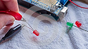 Red and green LED lights being shown in use as part of a microcontroller build