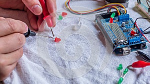 Red and green LED lights being shown in use as part of a microcontroller build