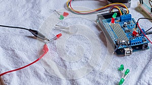 Red and green LED lights being shown in use as part of a microcontroller build