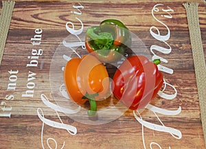 Red, green and orange peppers paprika on a table shown