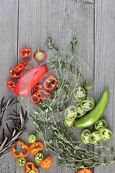 Red and green pepper on the wooden background
