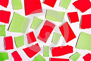 Red and green pieces of colored paper. Abstract colorful background. Torn paper on a white background.