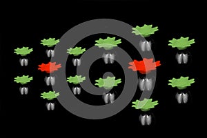 Red and green plastic objects with black background