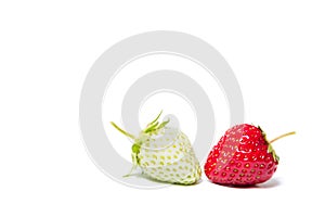 Red and green strawberries lying on a white background