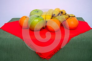 tablecloth with pears, bananas, oranges and fresh green apples