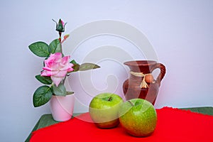 Red and green tablecloth with pears, bananas, oranges and fresh green apples