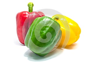 Red green and yellow bell peper on white background.