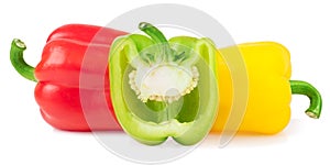 Red green yellow bell peppers with half isolated on white