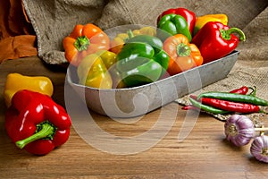 Red, green and yellow sweet bell peppers on table,