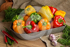 Red, green and yellow sweet bell peppers on table,